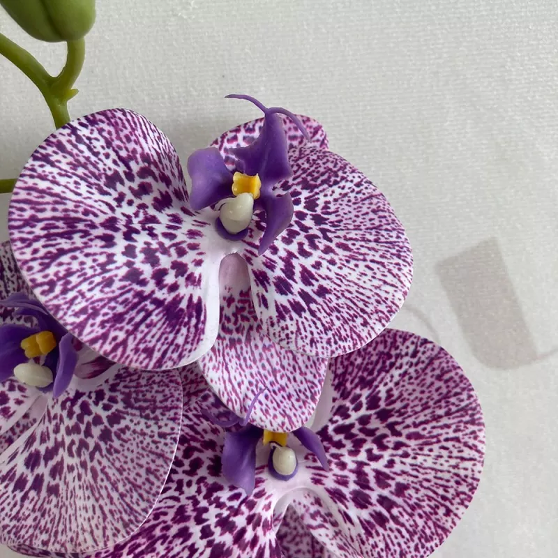 realistic faux orchid flower arrangement
